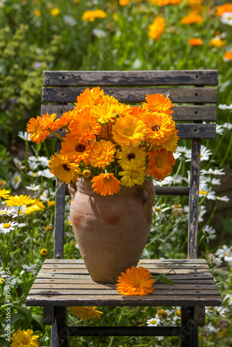 Obraz na płótnie Beautiful fresh summer flowers in a vase on chair w salonie