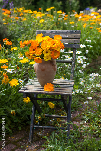 Beautiful fresh summer flowers in a vase on chair