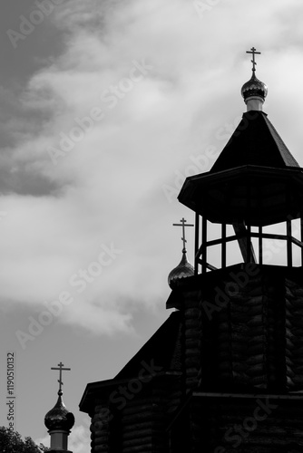 black and white photo of a church steeple against a cloudy sky