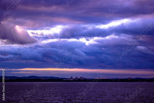 Dramatic sky with dark clouds over the city at sunset.
