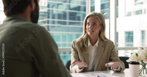 Happy confident blonde business leader woman talking to partner, job candidate, colleague man, speaking with hands moving, sitting at office meeting table, shaking hands with male coworker