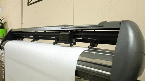 Cutting plotter close-up. The process of cutting a vinyl film.