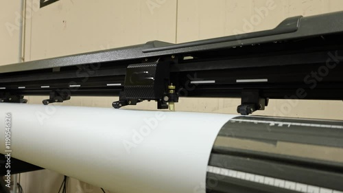 Cutting plotter close-up. The process of cutting a vinyl film.
