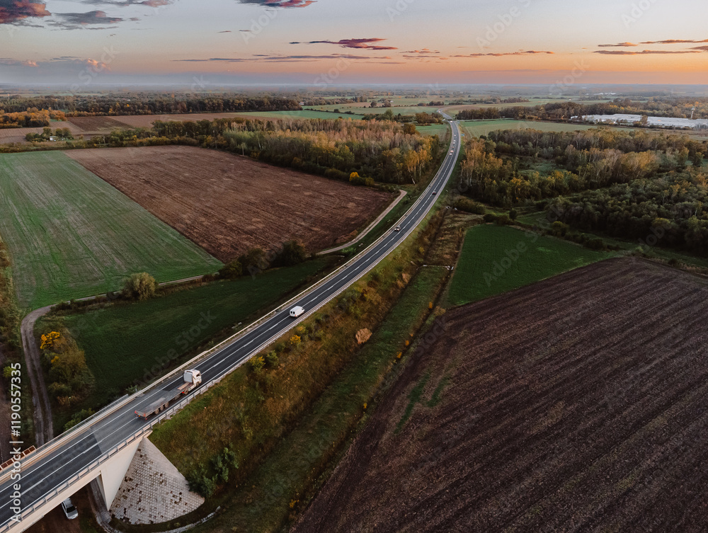 Aerial drone image from a bridge in the fields that is going over a railway Aerial drone image from a bridge in the fields that is going over a railway