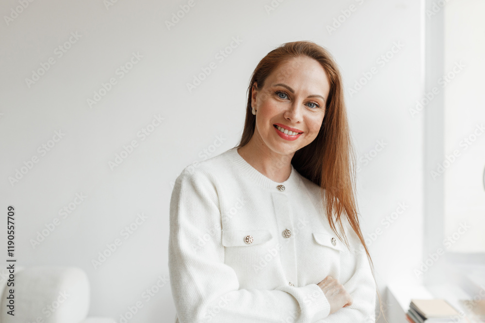 Indoor portrait of happy self-sufficient elegant redhead businesswoman in white jacket posing against blank copy space wall sharing tips and advice upon making business successful and profitable Indoor portrait of happy self-sufficient elegant redhead businesswoman in white jacket posing against blank copy space wall sharing tips and advice upon making business successful and profitable