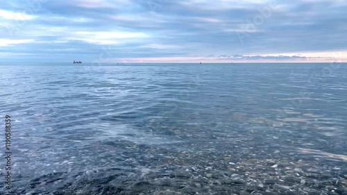 The calm, quiet surface of the sea. Sea waves. Clear sea at dawn