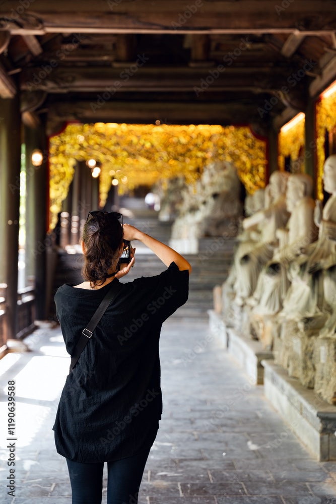 Stunning view of a tourist taking pictures at the Bai Dinh Temple. Bai Dinh Pagoda in Ninh Binh Vietnam is one of the largest pagoda complexes in Southeast Asia.