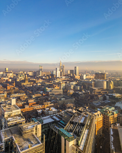 Aerial view cityscape of Leeds, West Yorkshire, in portrait or vertical orientation. Sunny day with blue sky