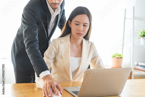 Disgusted asian young employee, pressure business woman uncomfortable, looking hand of boss or colleague  male when touching her hand while working. Sexual harassment inappropriate at office work.