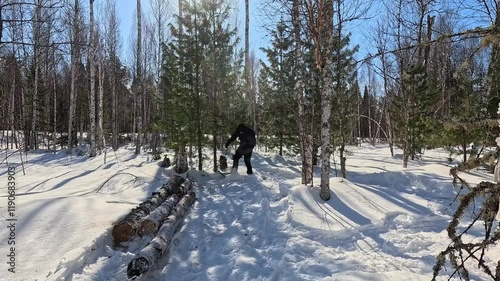 snowshoes. to trample down snow at the edge of the forest. a man in snowshoes tramples down snow to set up camp