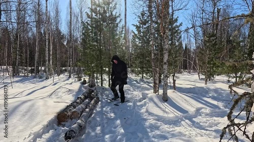 Walking through a winter forest in snowshoes. A man in snowshoes walks through a winter forest. Trampling snow with snowshoes. A MAN prepares a winter camp.