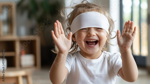 Blindfolded Child Clapping with Joy and Accomplishment photo