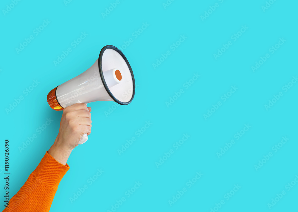 A vibrant hand holding a yellow megaphone against a blue background, symbolizing communication and announcement. A vibrant hand holding a yellow megaphone against a blue background, symbolizing communication and announcement.