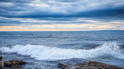 Waves Crashing on Rocky Shore at Dusk - Serene Ocean Scene with Dramatic Sky