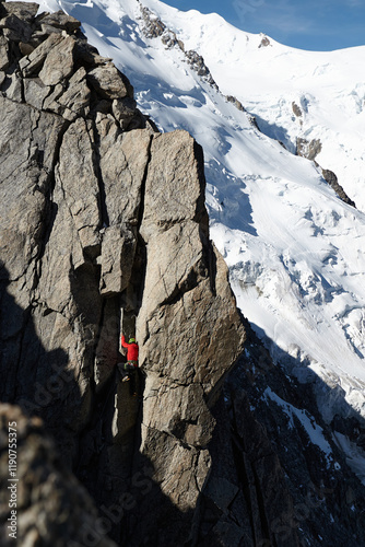 Rock climber climbing in alpine mountains
