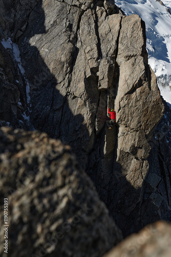 Rock climber climbing in alpine mountains