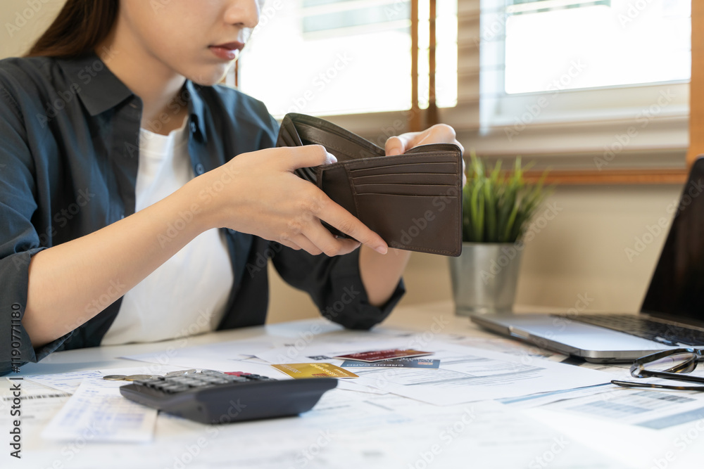 Φωτογραφία stressed young asian woman trying to find money to pay credit card debt