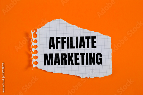 Affiliate marketing message written on ripped torn checkered graph paper piece with orange background. Conceptual affiliate marketing symbol. Copy space.