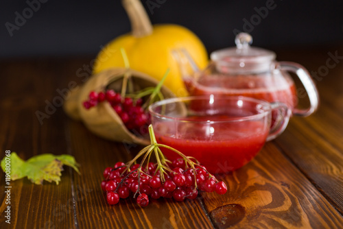 tea from ripe red viburnum on a wooden table photo