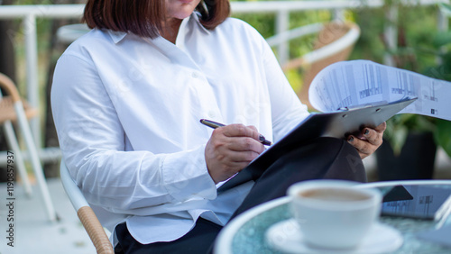 Business woman calculating expenses, managing budget, papers, loan documents, invoices. count taxes rental tenancy sum to pay online. businesswoman check company finances and earnings and budget.