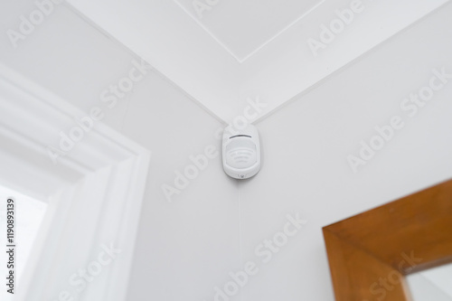 Newly installed wireless and battery operated new generation PIR alarm sensor in a downstairs room. Connected to a central alarm system which is activated on body heat.