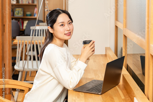 カフェで仕事中に一息つくアジア人女性01 photo