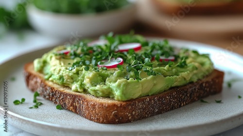 Delicious avocado toast topped with radish and herbs served on a rustic plate