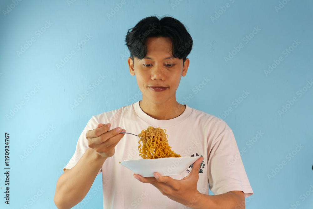 © Lailar Studio - Happy expression of Asian man eating noodles
