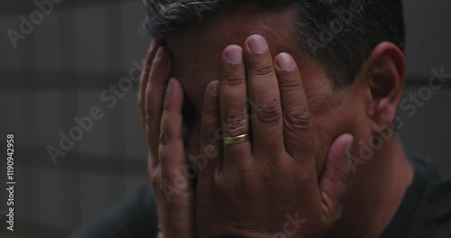 Man covering face and holding head with hands, overwhelmed by despair and emotional turmoil, conveying sadness, inner pain, mental struggle, and hopelessness during isolation