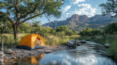 Camp near a tranquil river surrounded by colorful autumn foliage in a scenic ...
