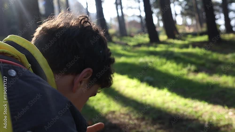 An attractive man smoking a cigarette in the woods. The smoking . A handsome young man in the forest An attractive man smoking a cigarette in the woods. The smoking . A handsome young man in the forest