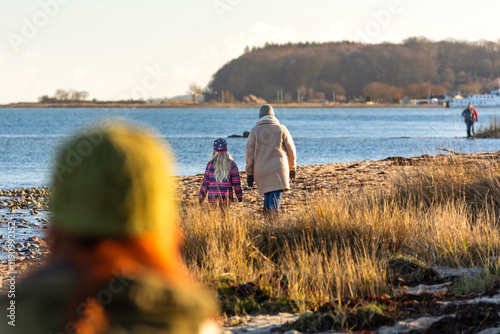 Fototapeta Naklejka Na Ścianę i Meble -  People walking through coastal landscape at the Baltic Sea
