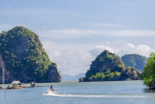 A distant natural background of a large mountain in the middle of the sea, Phang Nga Bay, Thailand, from a major viewpoint where tourists come to watch the sunrise in the morning. photo