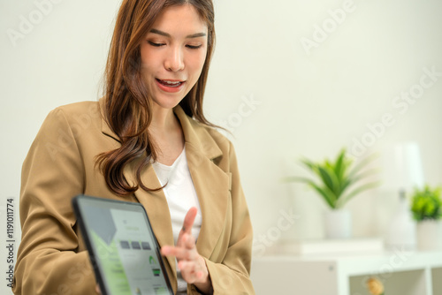The financial advisor uses digital tablet to analyze and calculate financial data with economic growth information to her customer , business strategy and planning concepts.