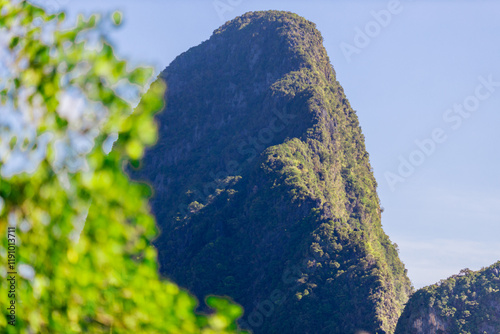 A distant natural background of a large mountain in the middle of the sea, Phang Nga Bay, Thailand, from a major viewpoint where tourists come to watch the sunrise in the morning. photo