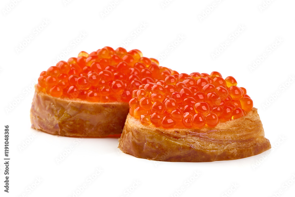 Red caviar on a crispy bread slice, isolated on white background. Red caviar on a crispy bread slice, isolated on white background.