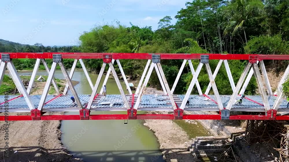 River bridge construction workers tropical setting River bridge construction workers tropical setting
