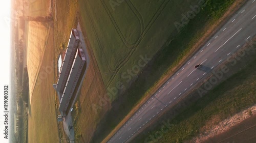 Bike driving on the road on sunset. Vertical video. Drone