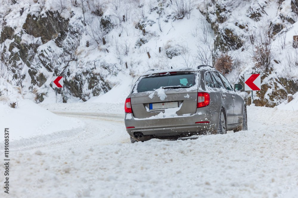 Car on the snowy mountain road during severe conditions Car on the snowy mountain road during severe conditions