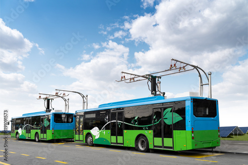 Electric buses at a bus station. Solar panels in the background