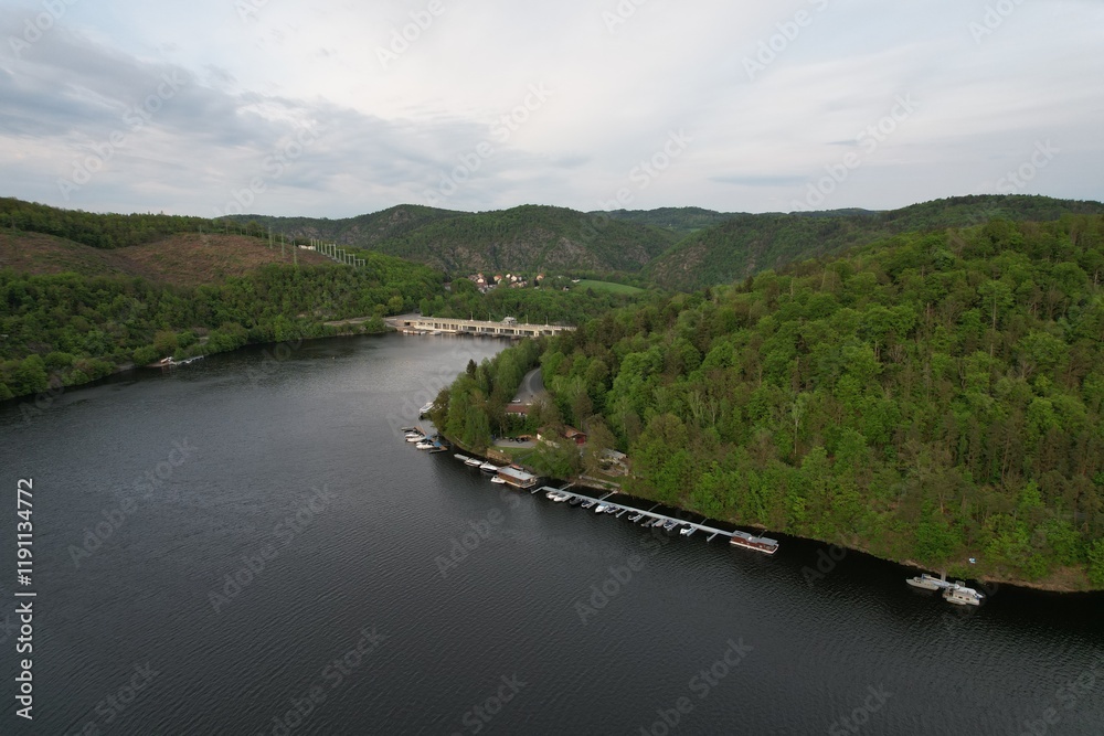 Fototapeta premium Slapy Reservoir is dam on the Vltava river in the Czech Republic, near to village Slapy. It has a hydroeletrics power station included.Aerial panorama landscape photo 