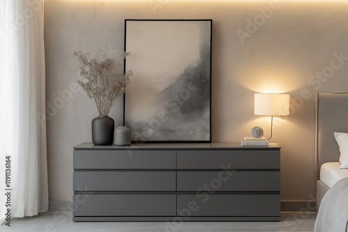 Contemporary grey dresser with sleek handleless drawers in a chic modern bedroom with soft beige walls, warm ambient lighting, and a large framed abstract painting above. photo