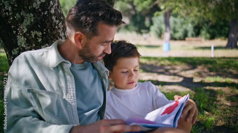 Daddy child reading fairytale gathering in forest closeup. Father son talking