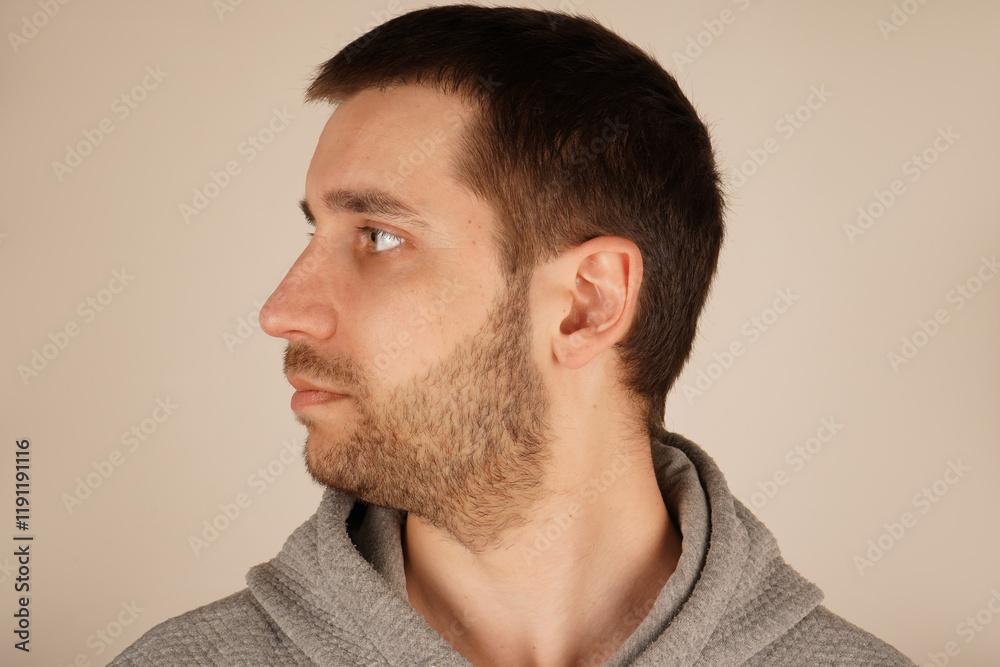 Fototapeta premium The lighting accentuates the calmness of his demeanor. A man s calm head is shown in this close-up shot. His composed expression and gentle features exude a sense of inner peace.