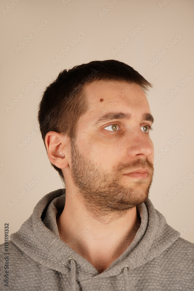Obraz premium His composed expression and gentle features exude a sense of inner peace. The lighting accentuates the calmness of his demeanor. A man s calm head is shown in this close-up shot.