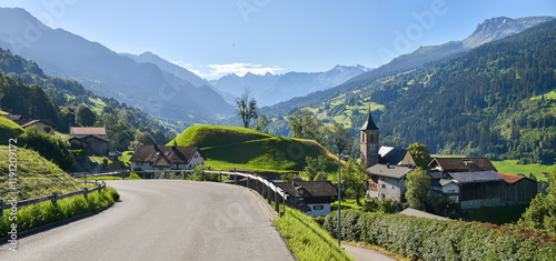 alpine road through idyllic village Luzein, view to Prattigau valley, switzerland photo