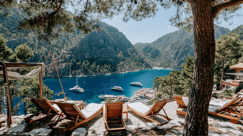 Obraz na płótnie luxury resort with panoramic views and secluded cove in oludeniz turkey along the aegean coast featuring yacht and sea views from wooden lounge chairs with scenic mediterranean backdrop w salonie