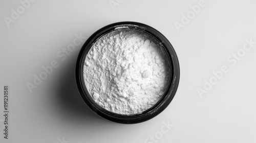 White powder in a black round jar