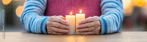 Elderly Hands Holding Two Lit Candles Against Soft Background, Symbolizing Peace, Hope, and Reflection in a serene Outdoor Setting During Golden Hour. photo