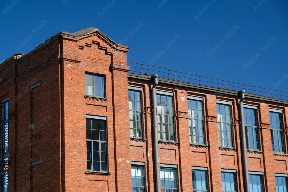red brick building with large windows and blue sky red brick building with large windows and blue sky